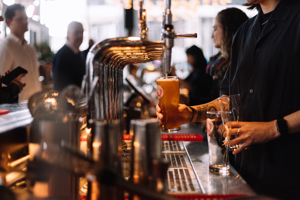 a man pouring a drink at a bar