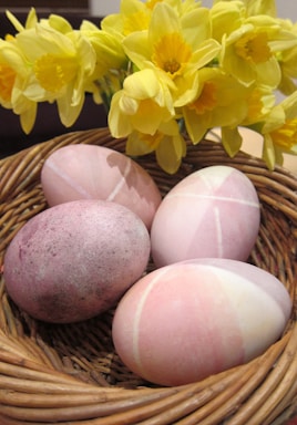 Close-up of colorful eggs in a rustic basket.