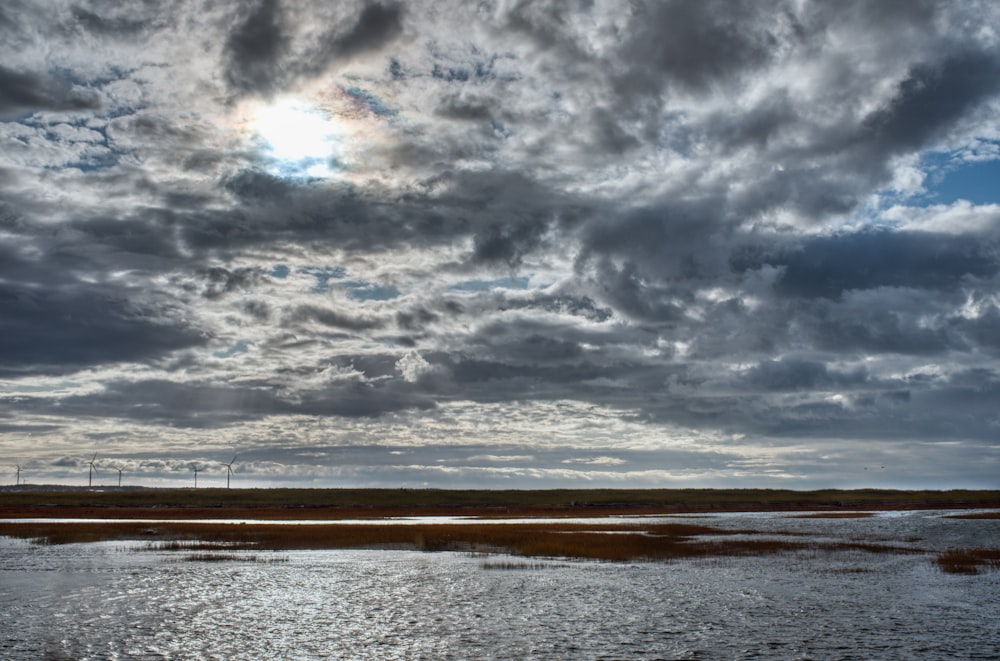 a large body of water under a cloudy sky