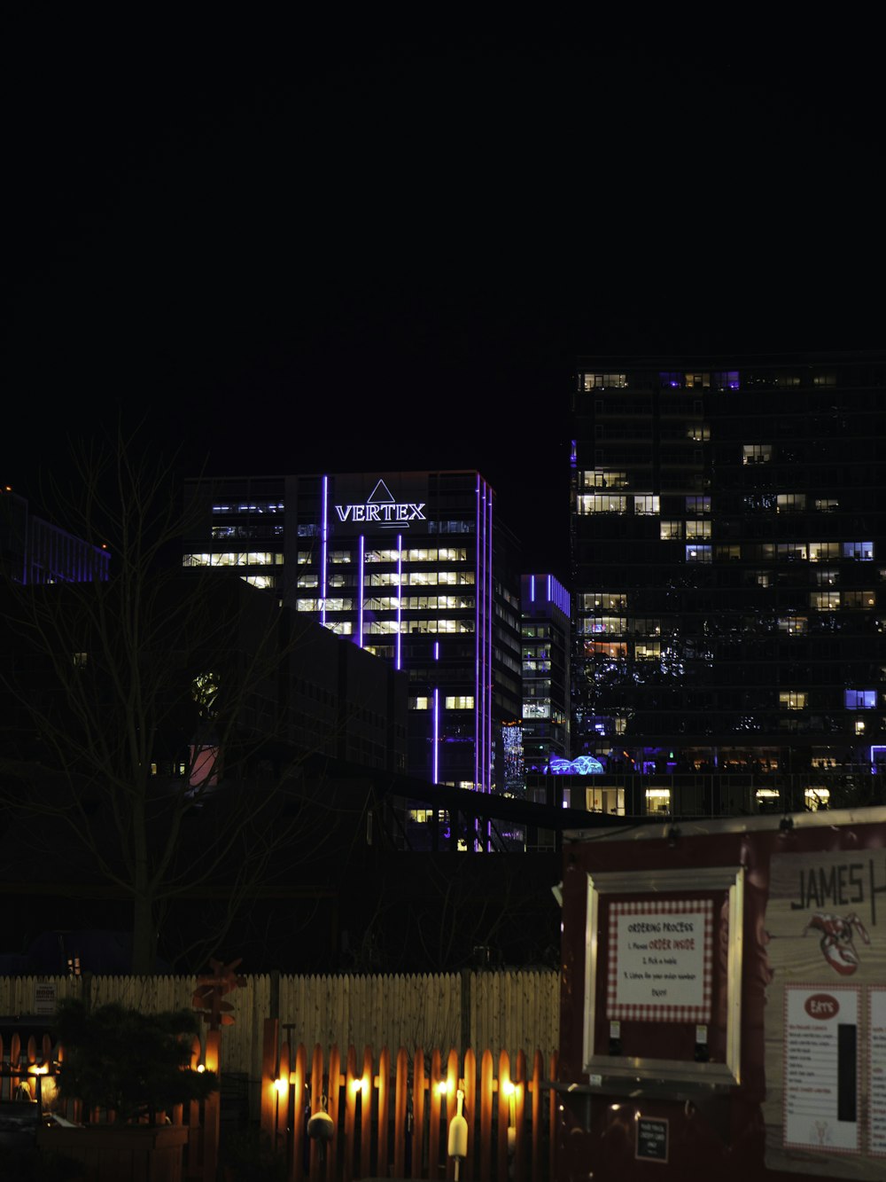 a view of a city at night from across the street