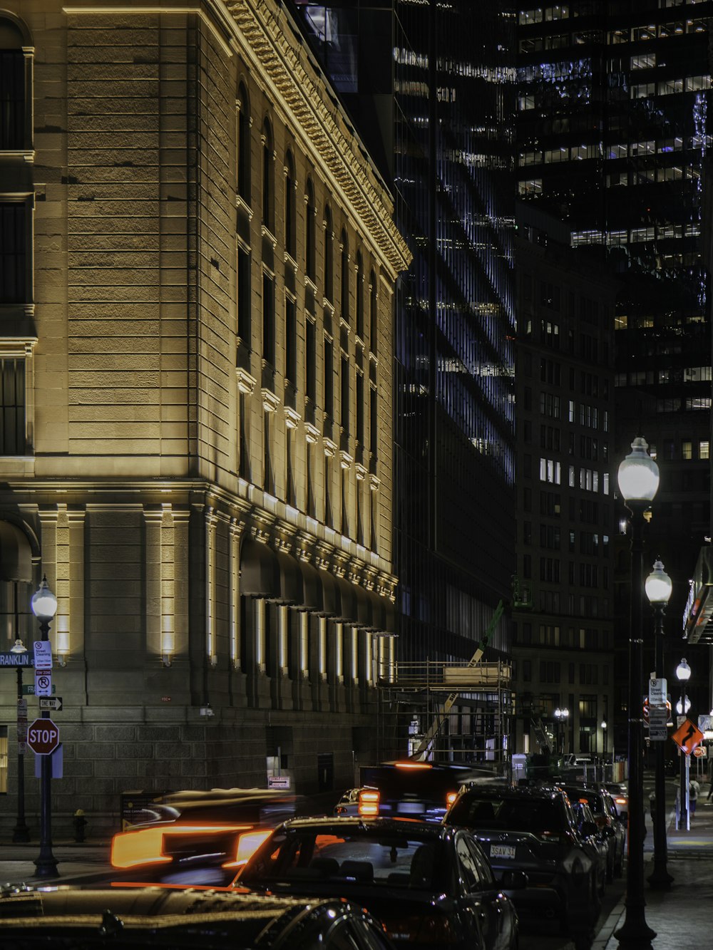 a city street at night filled with traffic