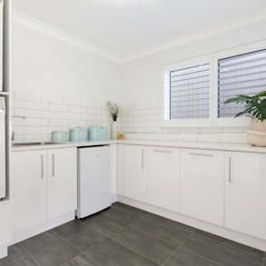 a washer and dryer in a white kitchen