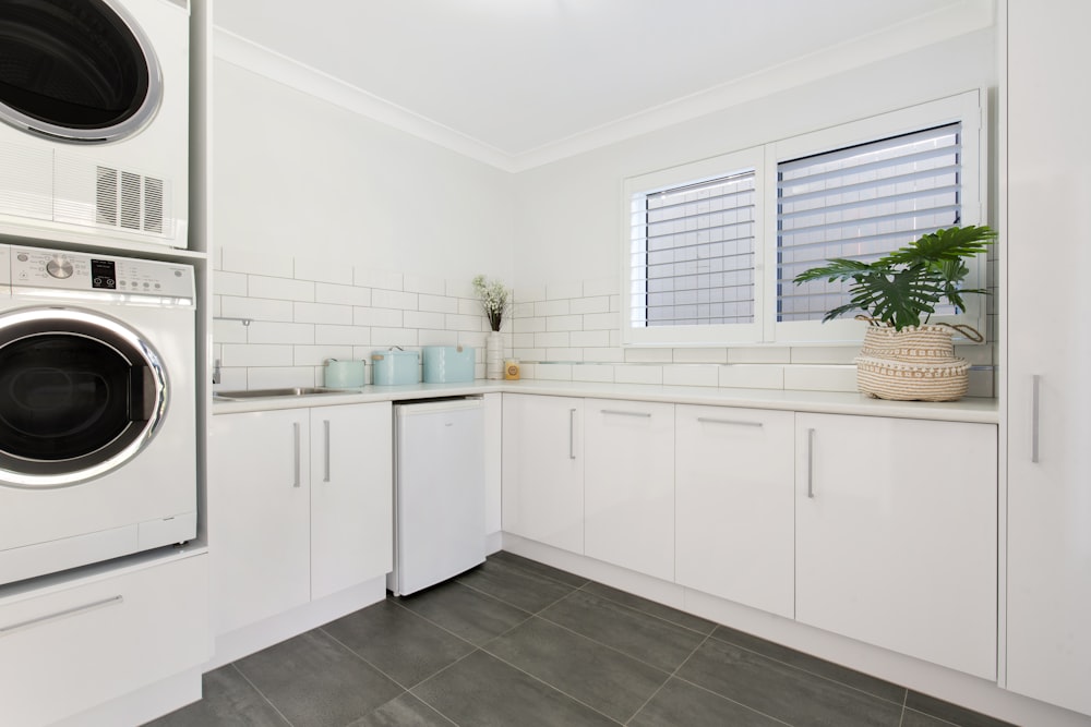 a washer and dryer in a white kitchen