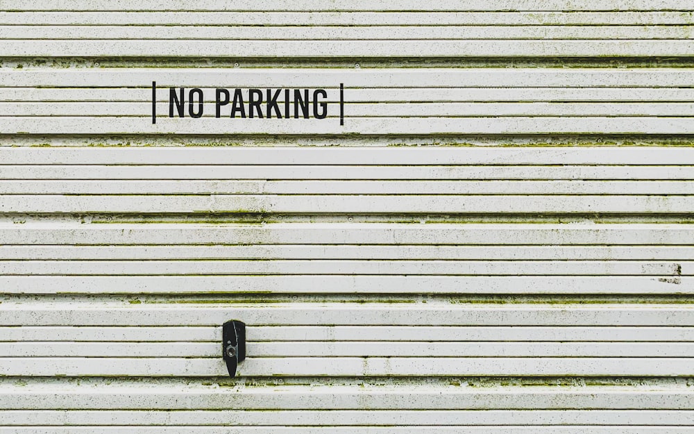a no parking sign on the side of a building
