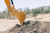a bulldozer digging dirt in the desert
