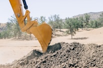 a bulldozer digging dirt in the desert