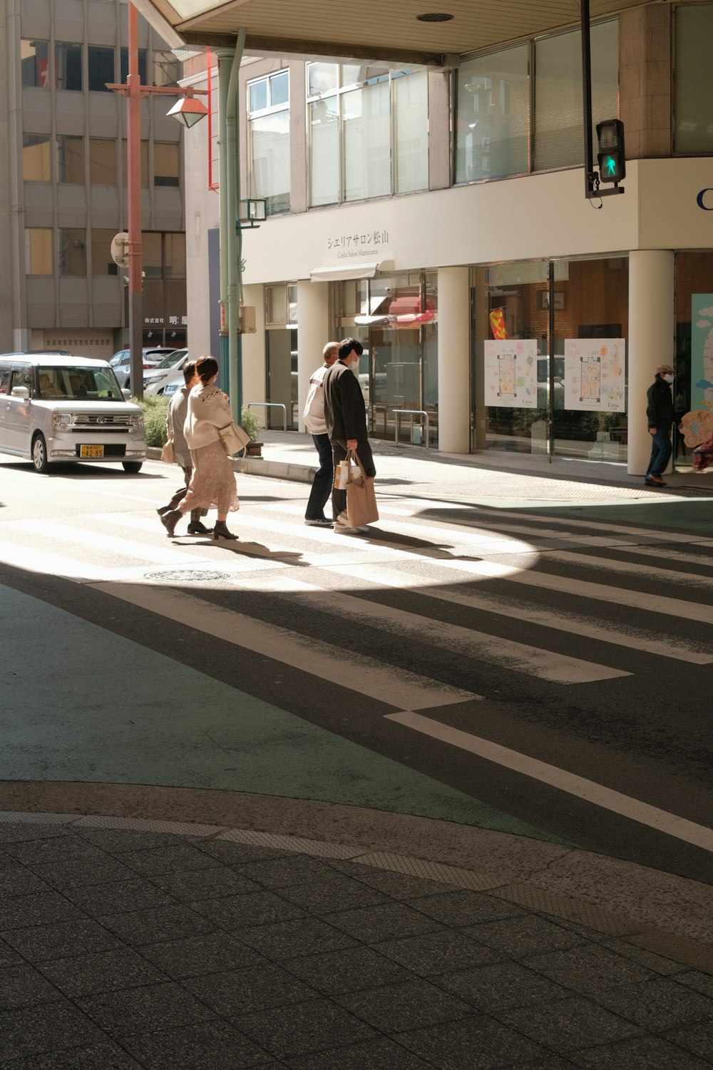 a couple of people walking across a street