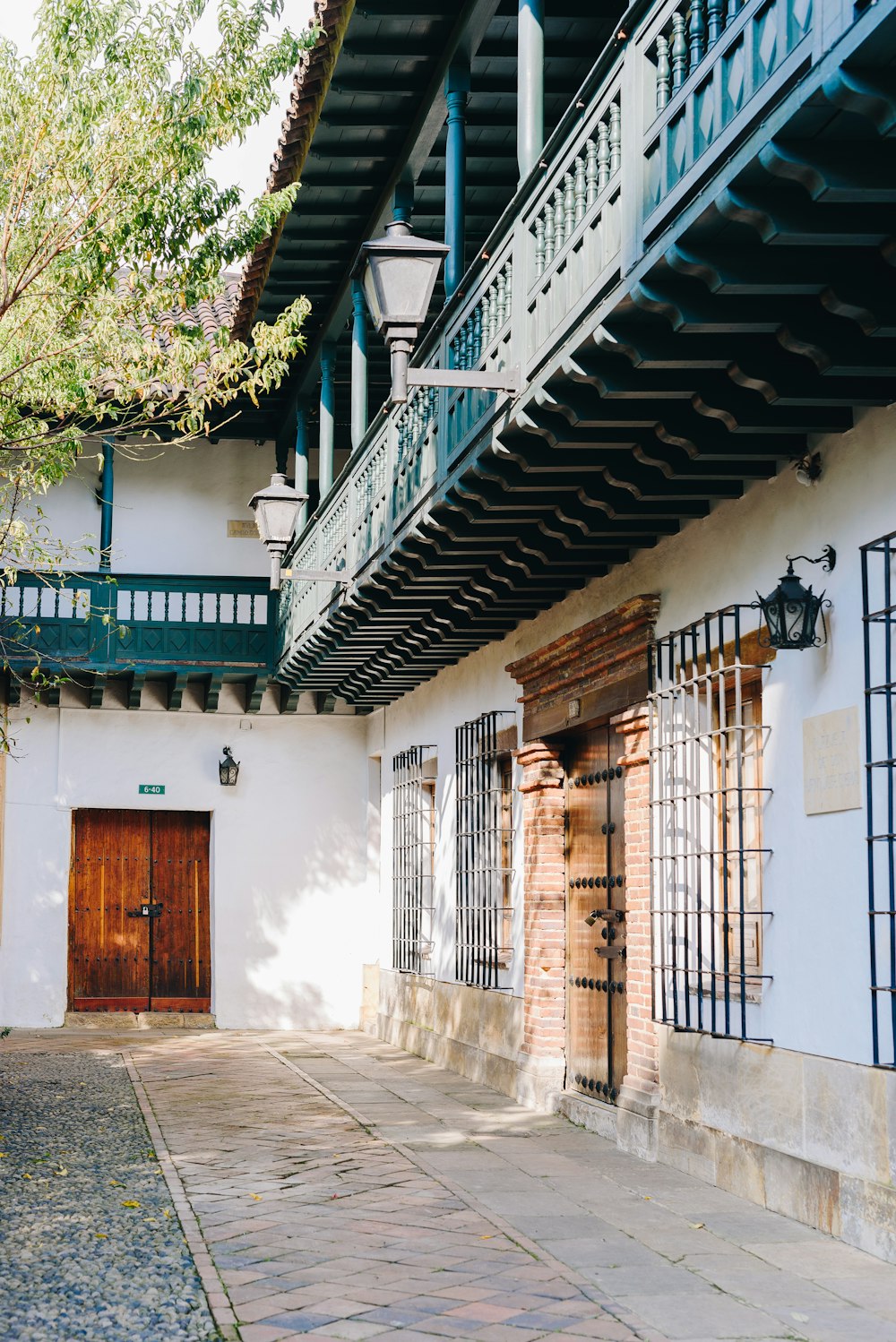 a white building with a wooden door and balcony