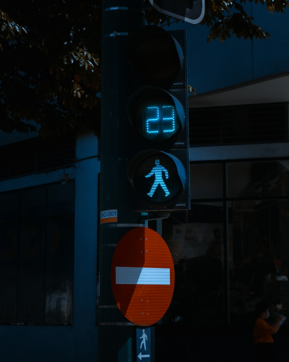 a traffic light with a pedestrian walk sign on it