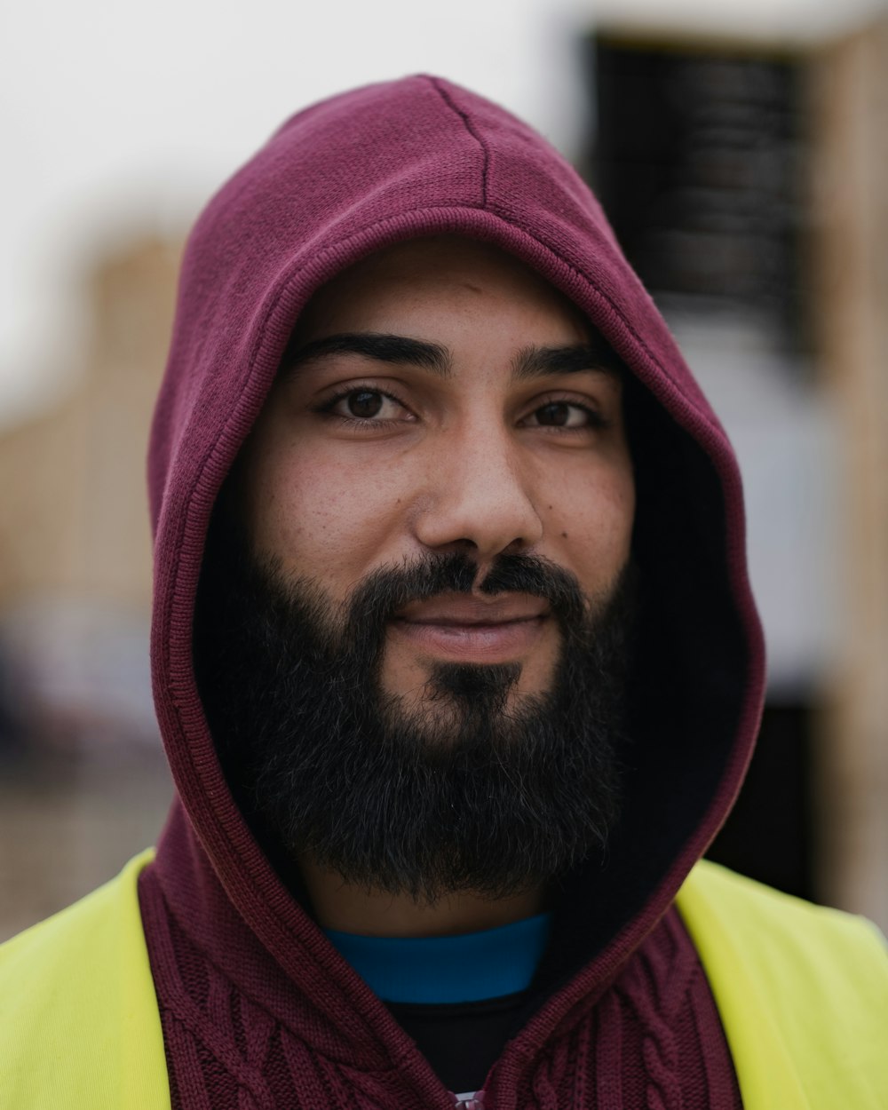 a man with a beard wearing a yellow vest