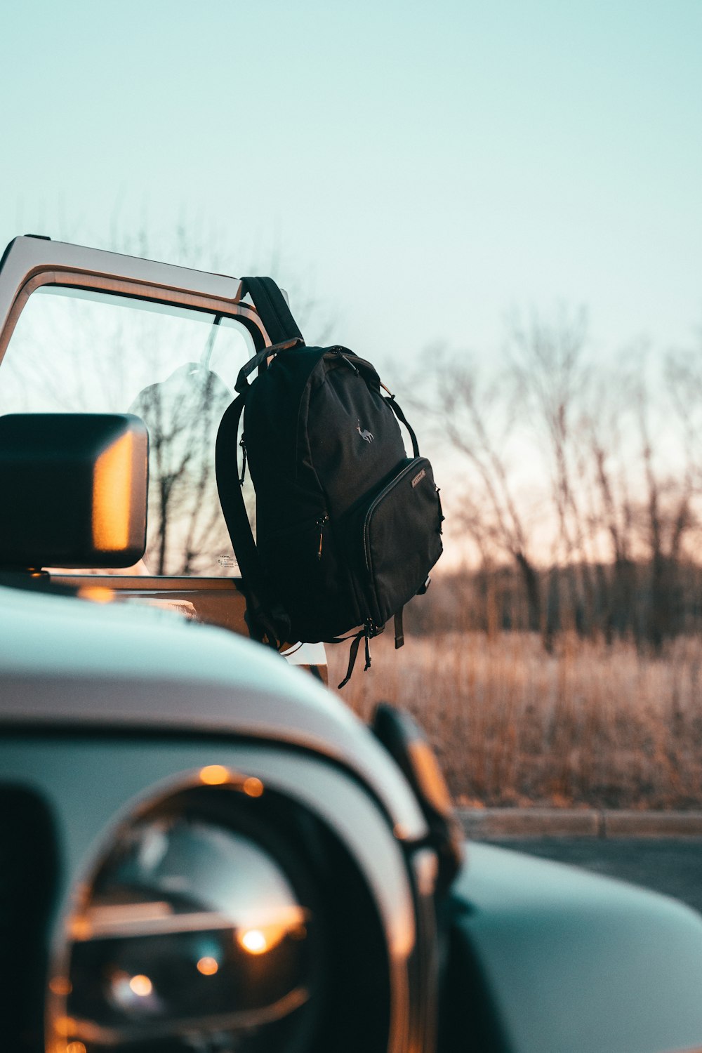 a backpack hanging on the back of a car