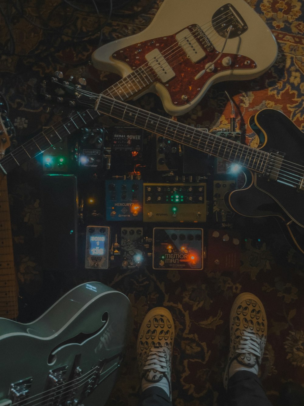 a person standing next to a guitar and other musical instruments