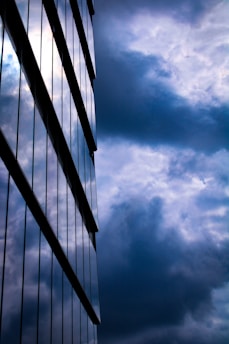 a tall building sitting under a cloudy blue sky