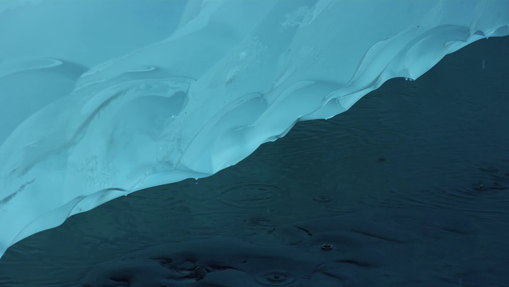 a large iceberg with water flowing down it's sides