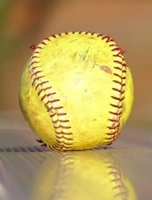 a yellow baseball sitting on top of a table