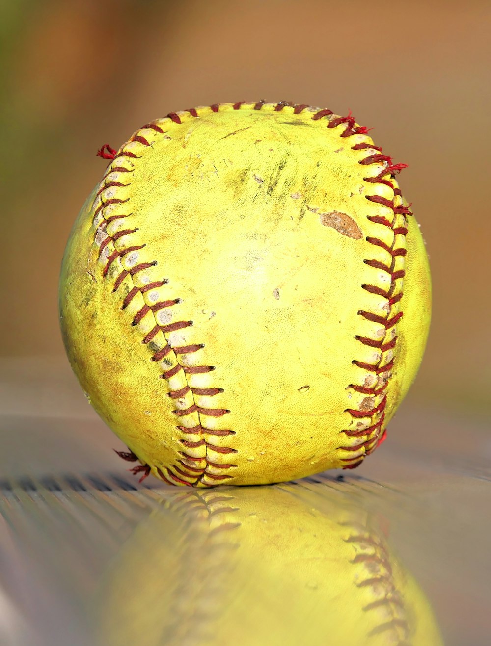 a yellow baseball sitting on top of a table