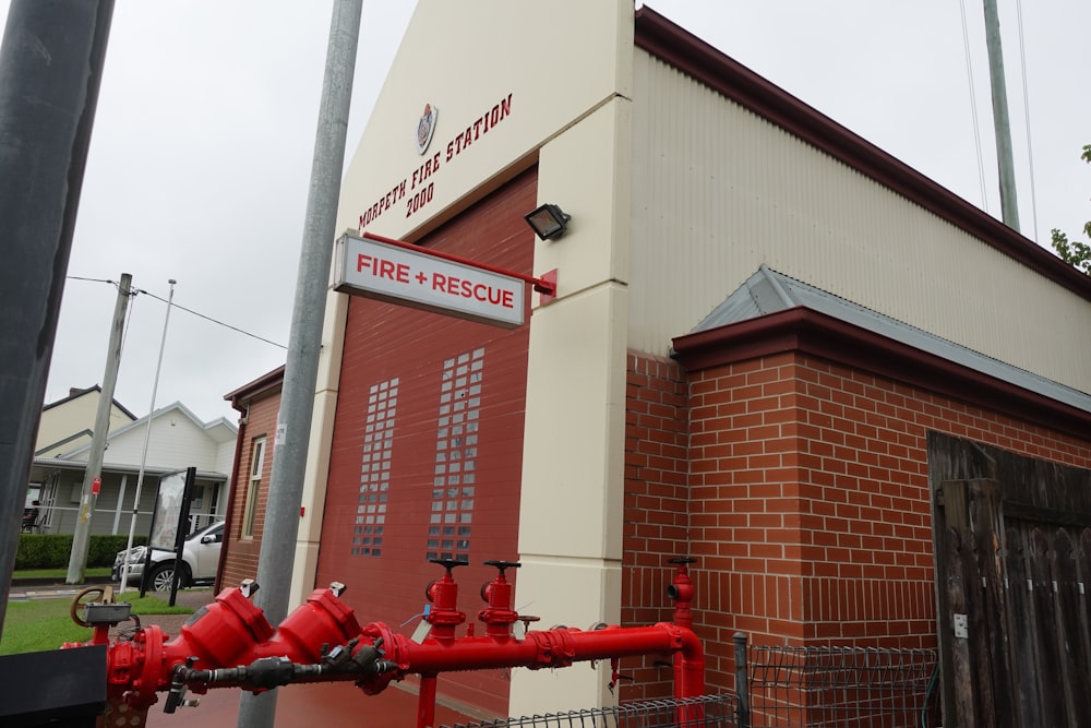 a red fire hydrant sitting in front of a building