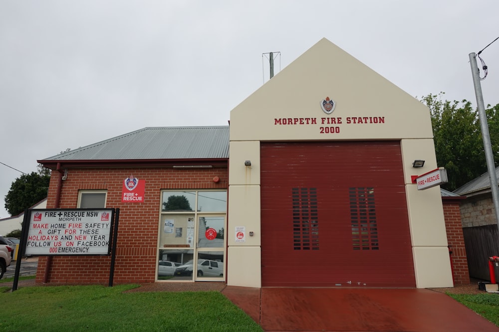 a fire station with a red door and a sign