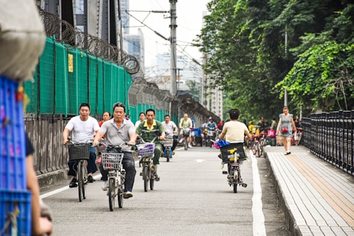 a group of people riding bikes down a street