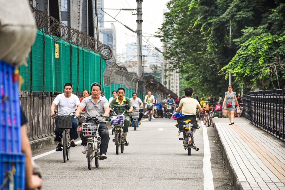 a group of people riding bikes down a street