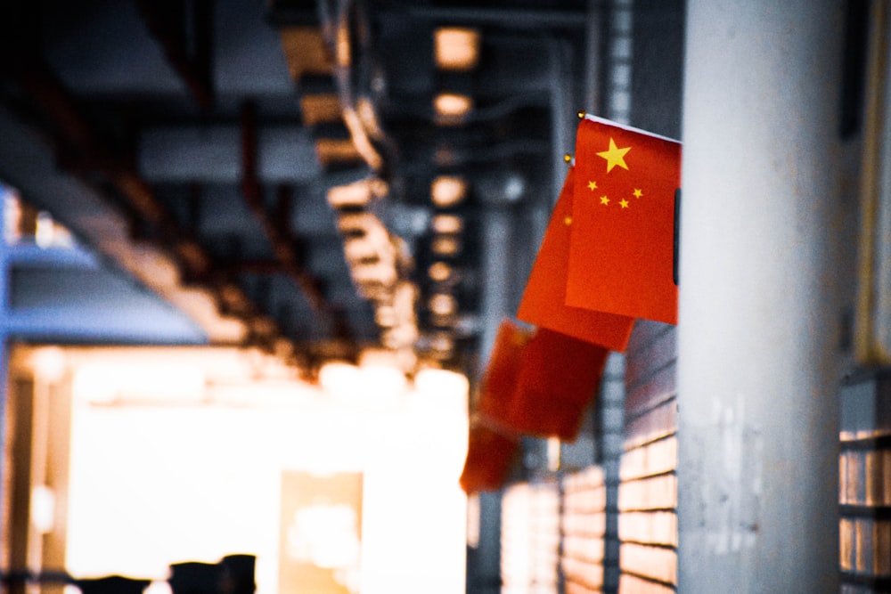 a chinese flag hanging from the side of a building