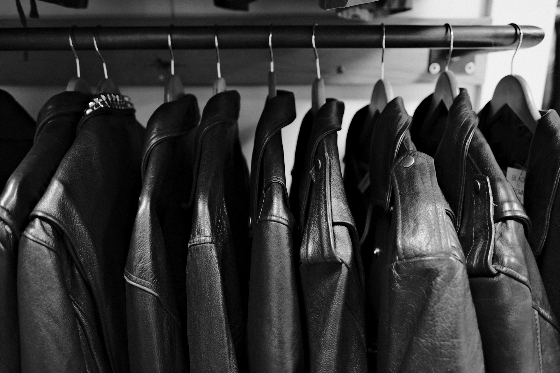 a row of leather jackets hanging on a rack