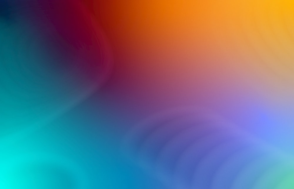 a blurry image of a rainbow colored background