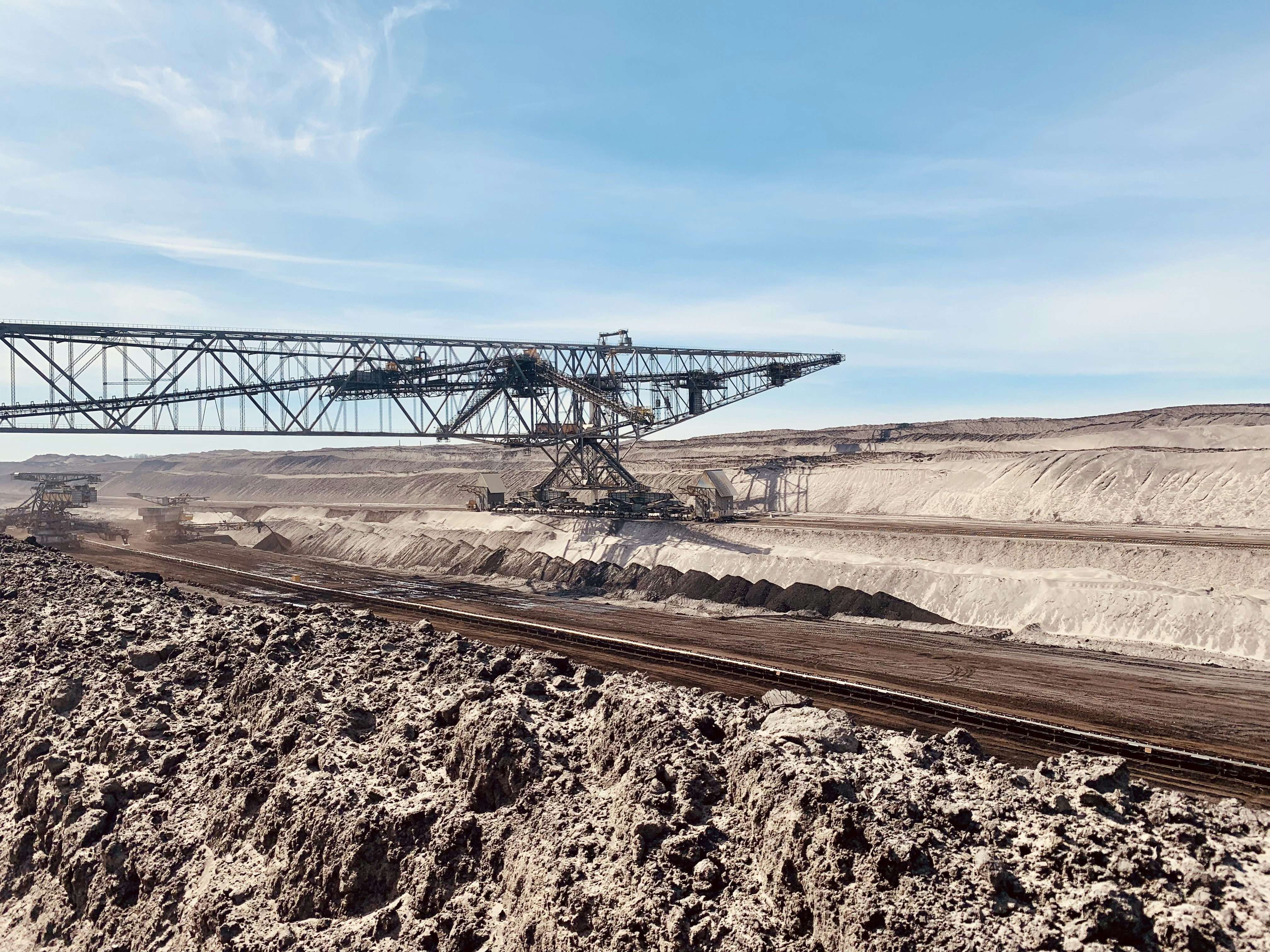 a train traveling through a desert under a blue sky