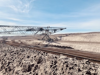 a train traveling through a desert under a blue sky