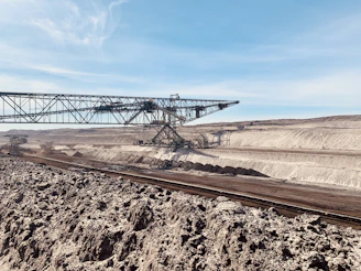 a train traveling through a desert under a blue sky