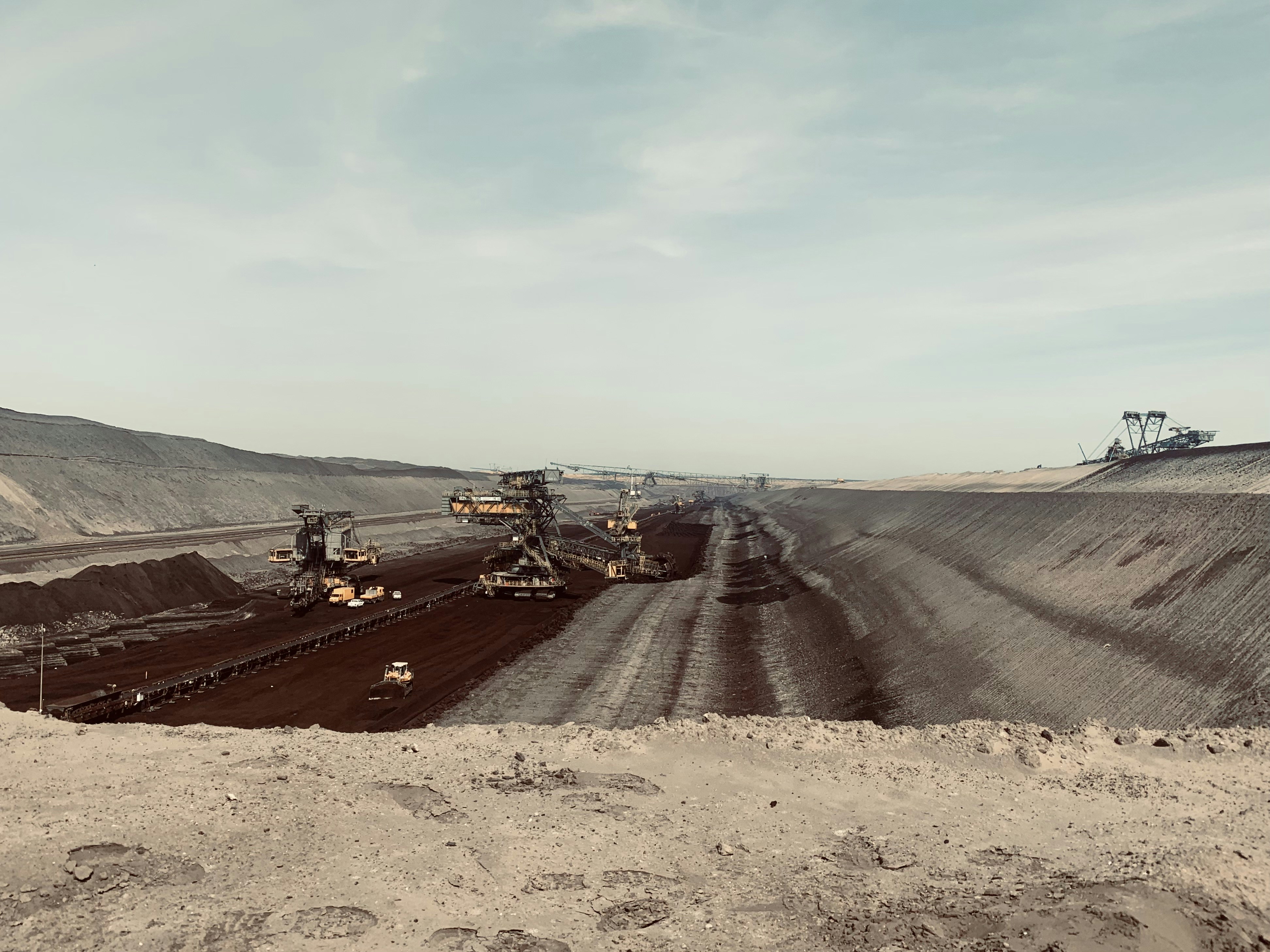 a large open pit with machinery in the middle of it