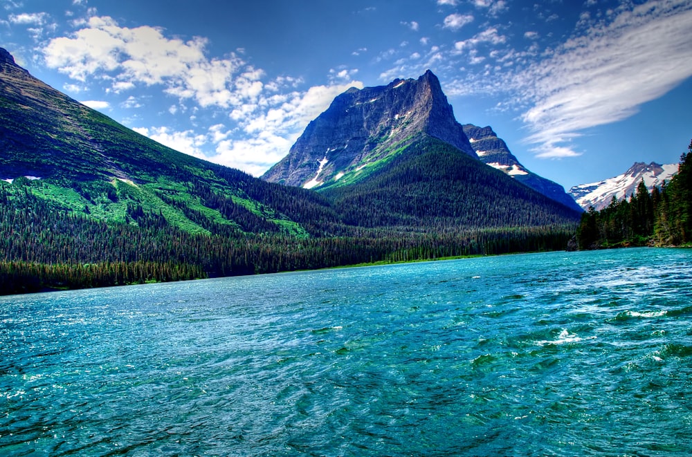 a body of water with mountains in the background