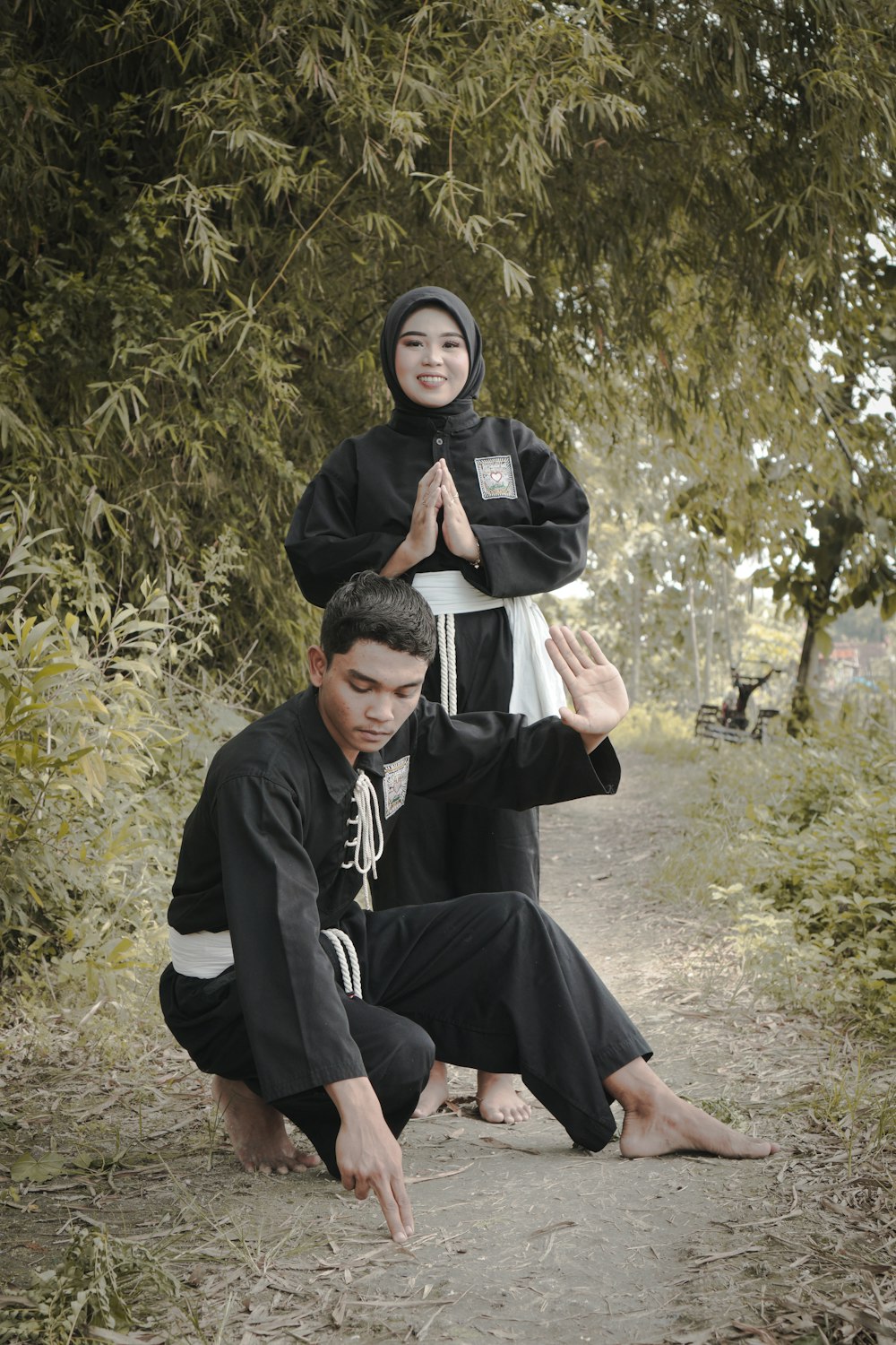 a man kneeling down next to a woman