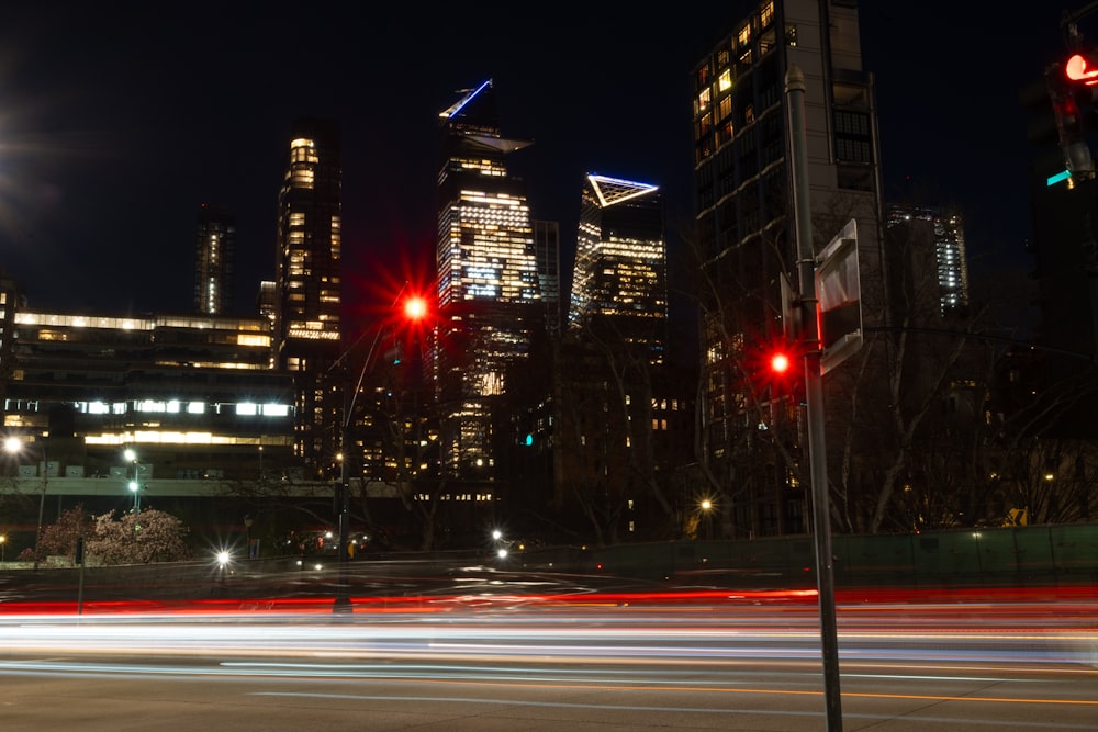 a city at night with traffic lights and skyscrapers