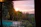 A serene view of a private pool with lush tropical garden in the background during golden hour.