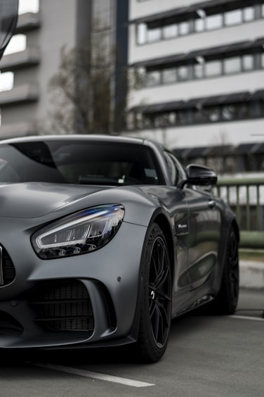a grey sports car parked in a parking lot