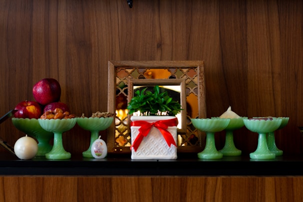A cheerful arrangement of candles and decorative items on a shelf.