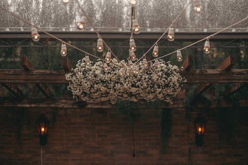 a bunch of flowers hanging from a ceiling