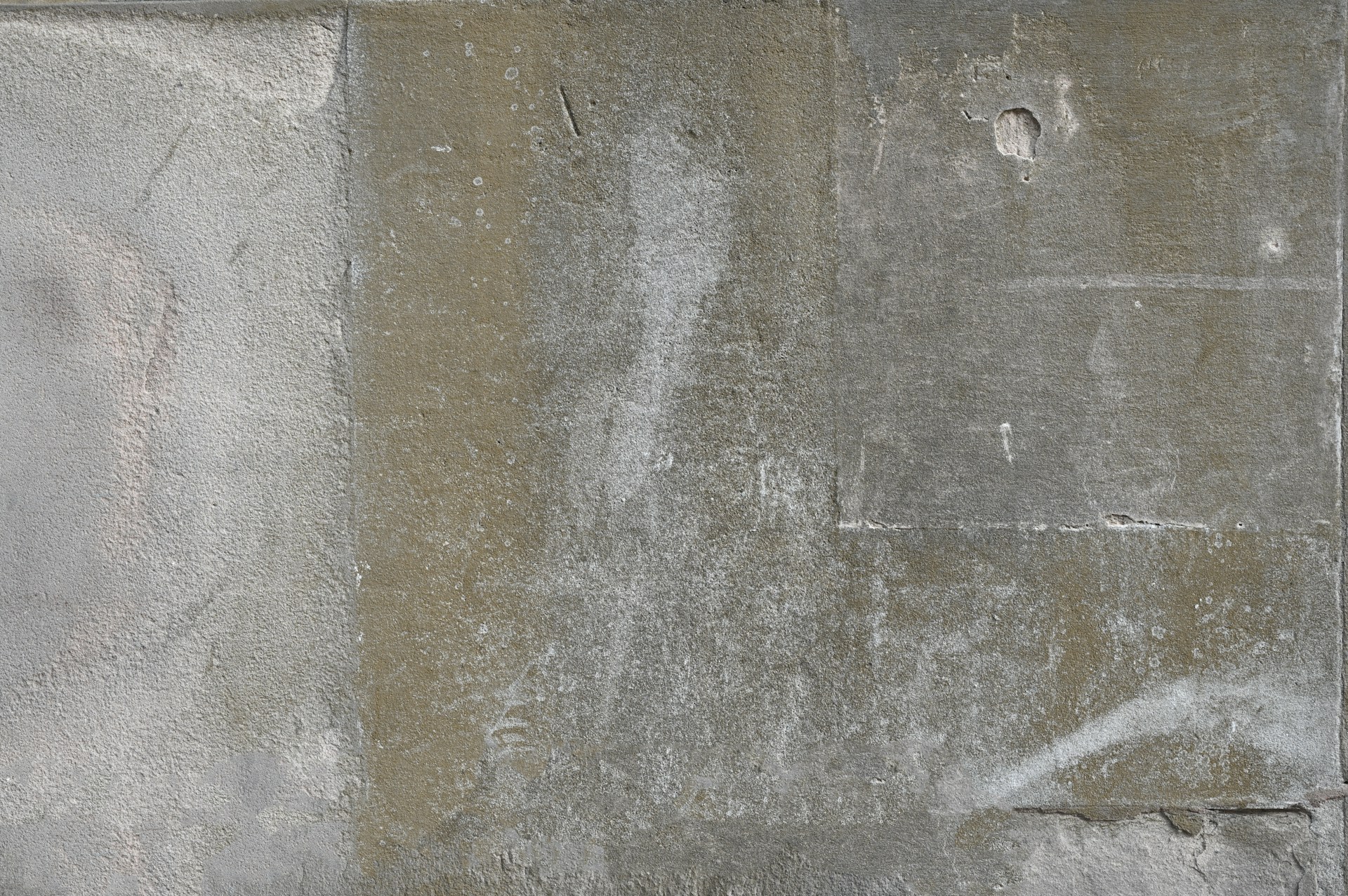 a white fire hydrant sitting on the side of a cement wall