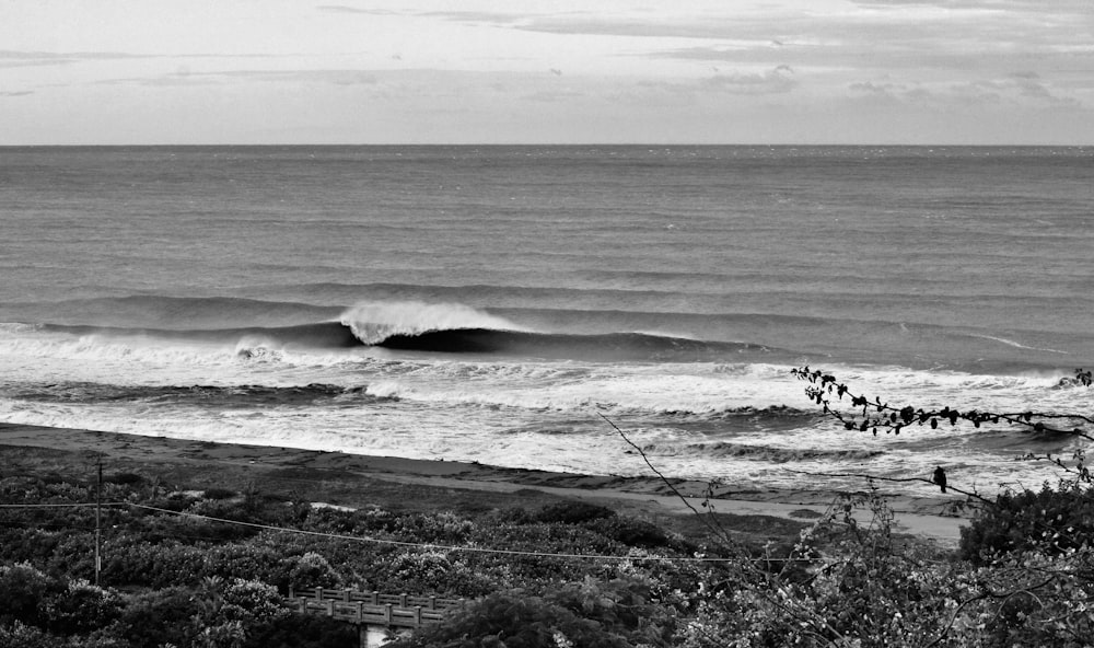 a black and white photo of a large wave