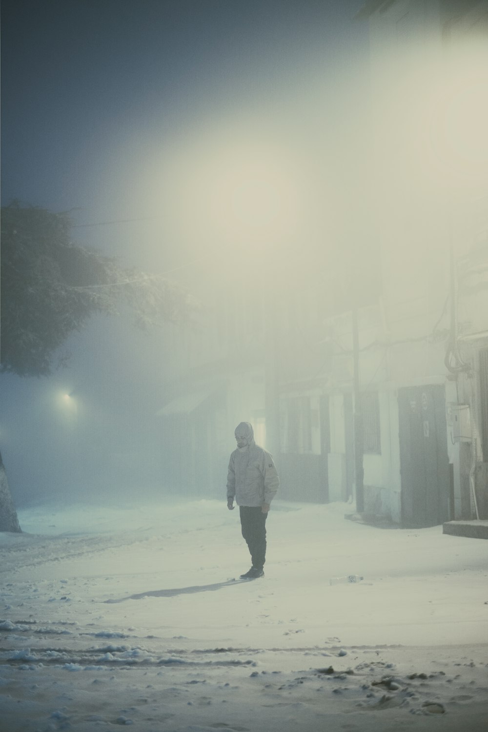 a person walking in the snow at night