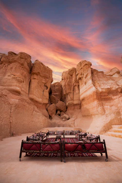 A vibrant networking event with members exchanging ideas against a backdrop of red sandstone cliffs.