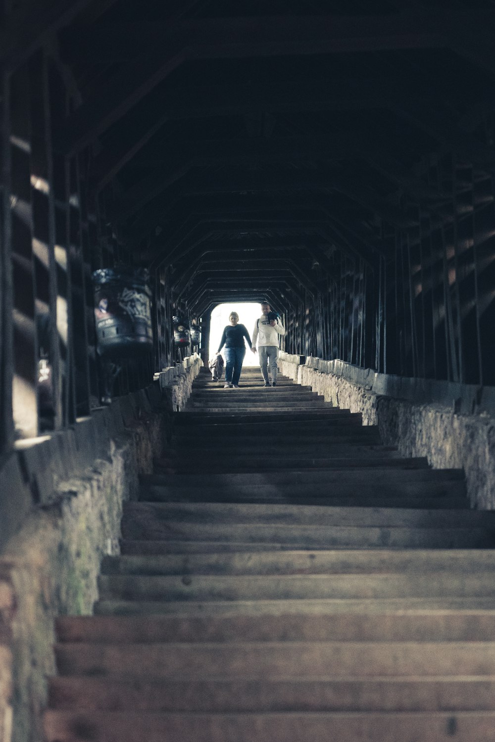 a person walking up some steps in a tunnel