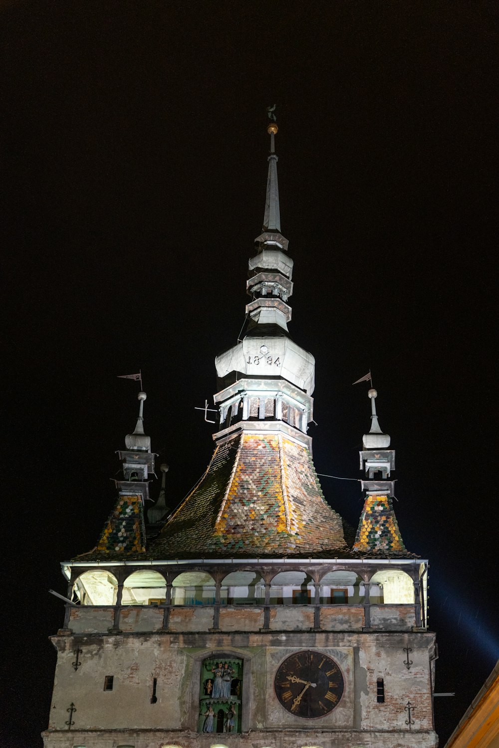 a tall clock tower with a clock on each of it's sides