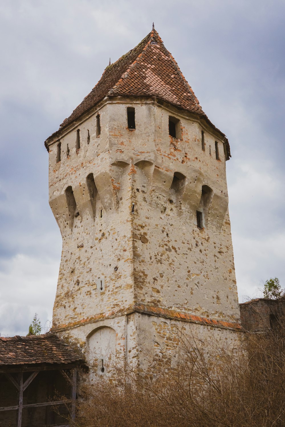 a very tall tower with a clock on it's side