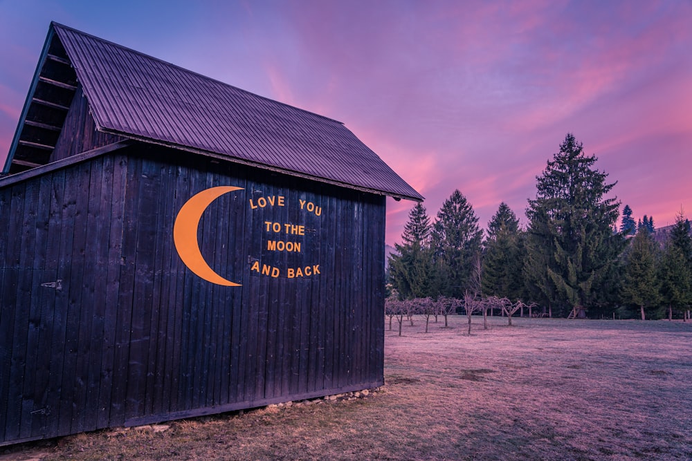 a barn with a love you to the moon and back written on it