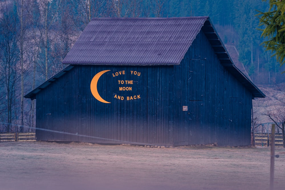 a barn with a painted on the side of it