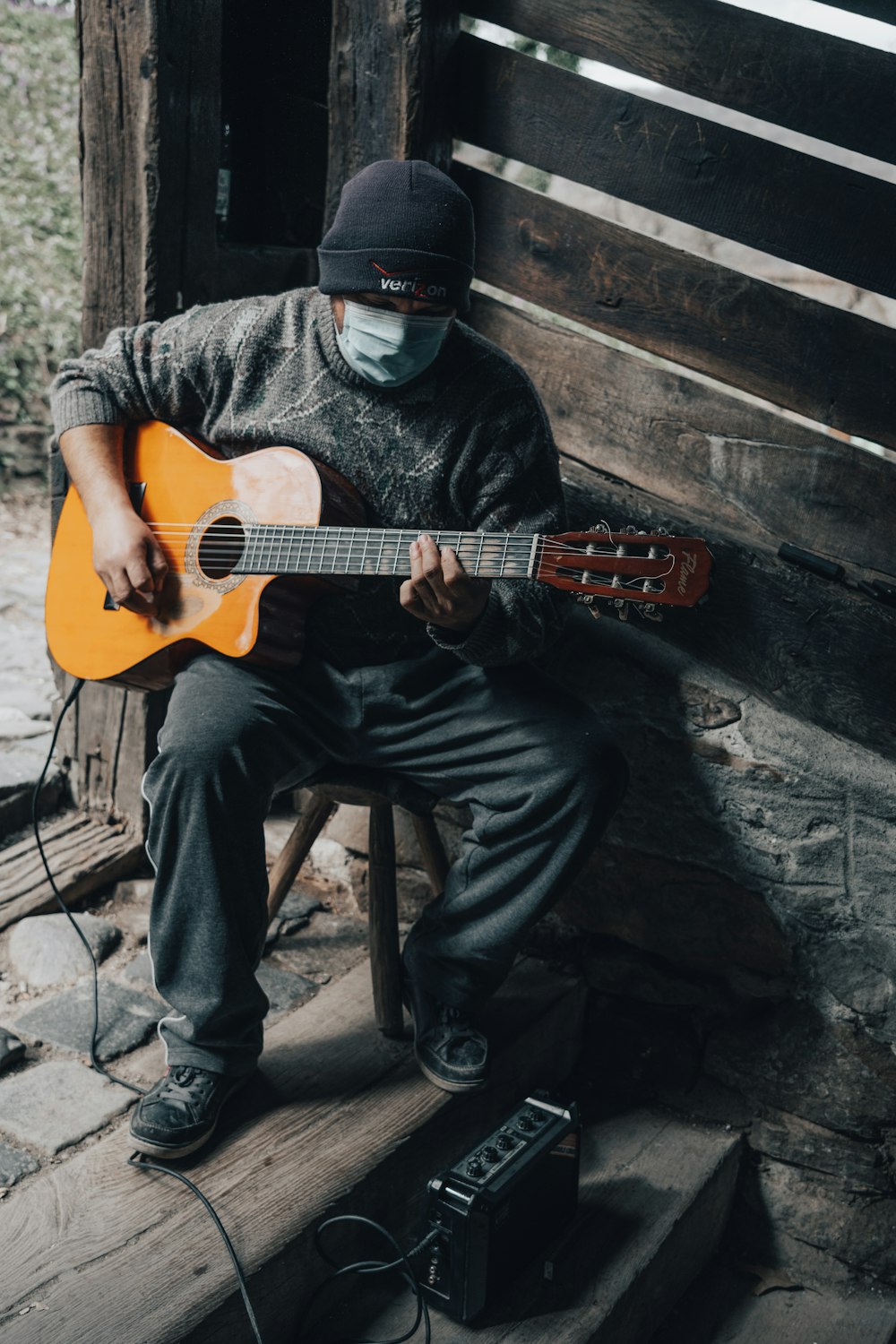a man wearing a mask playing a guitar