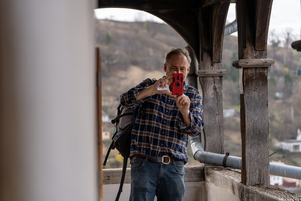 a man taking a picture of himself with his cell phone