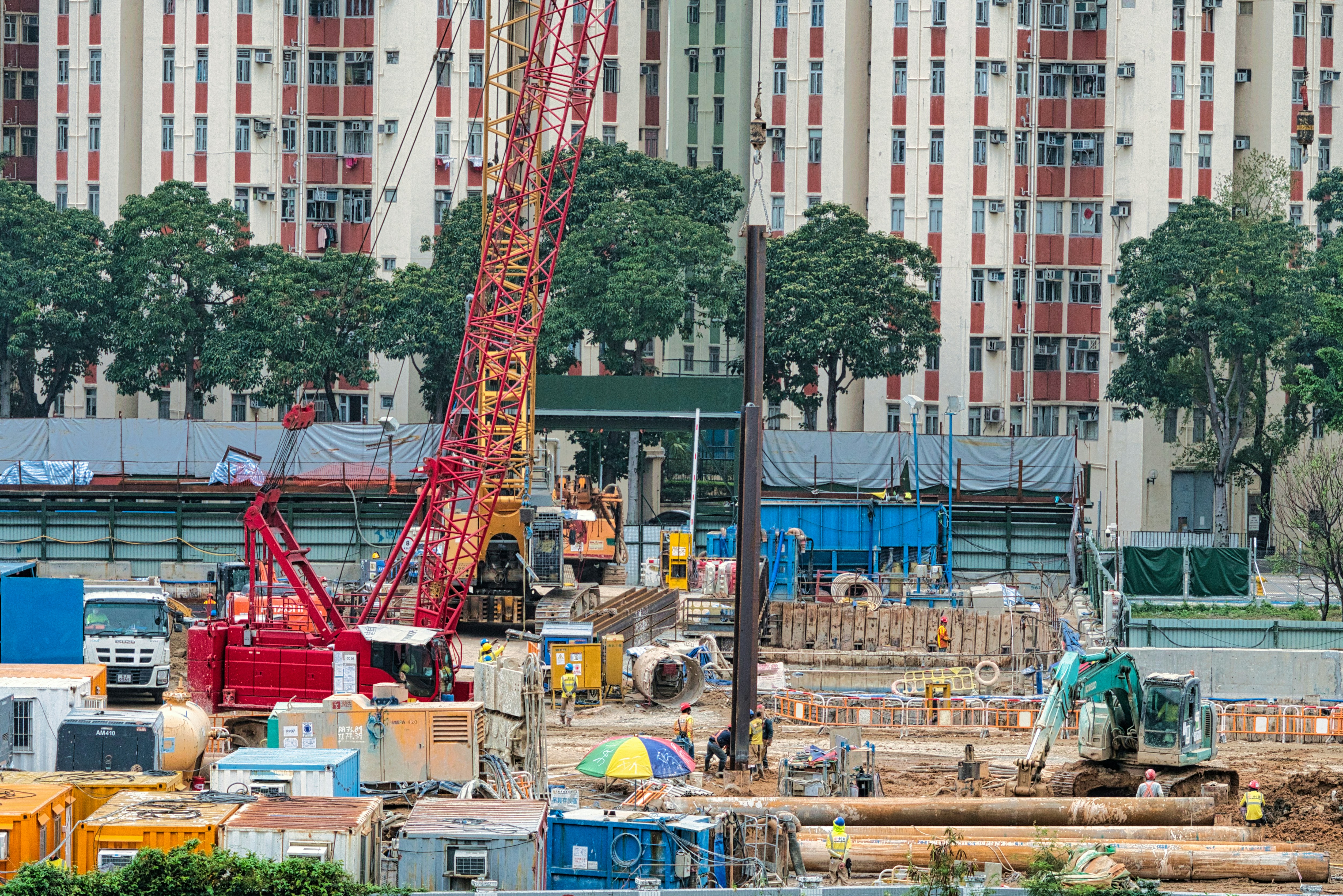 a construction site with a crane in the foreground